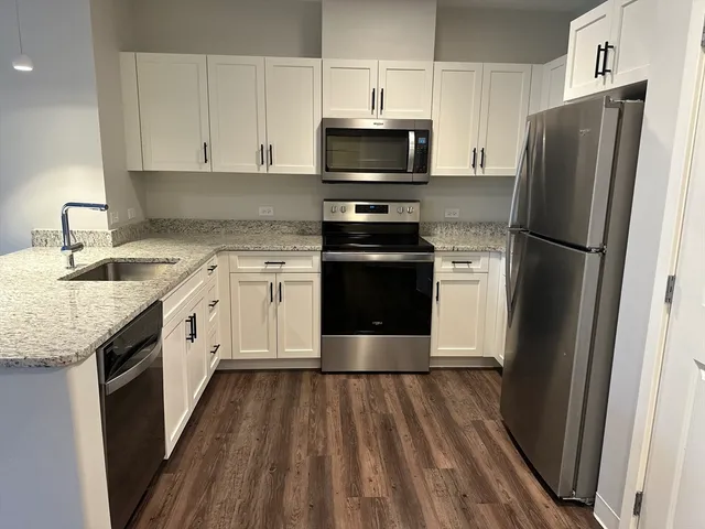 a kitchen with a sink stove and refrigerator