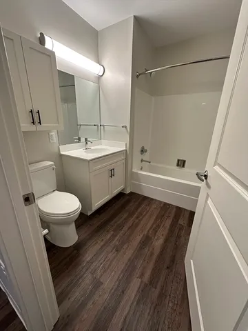 a bathroom with a toilet sink and a mirror