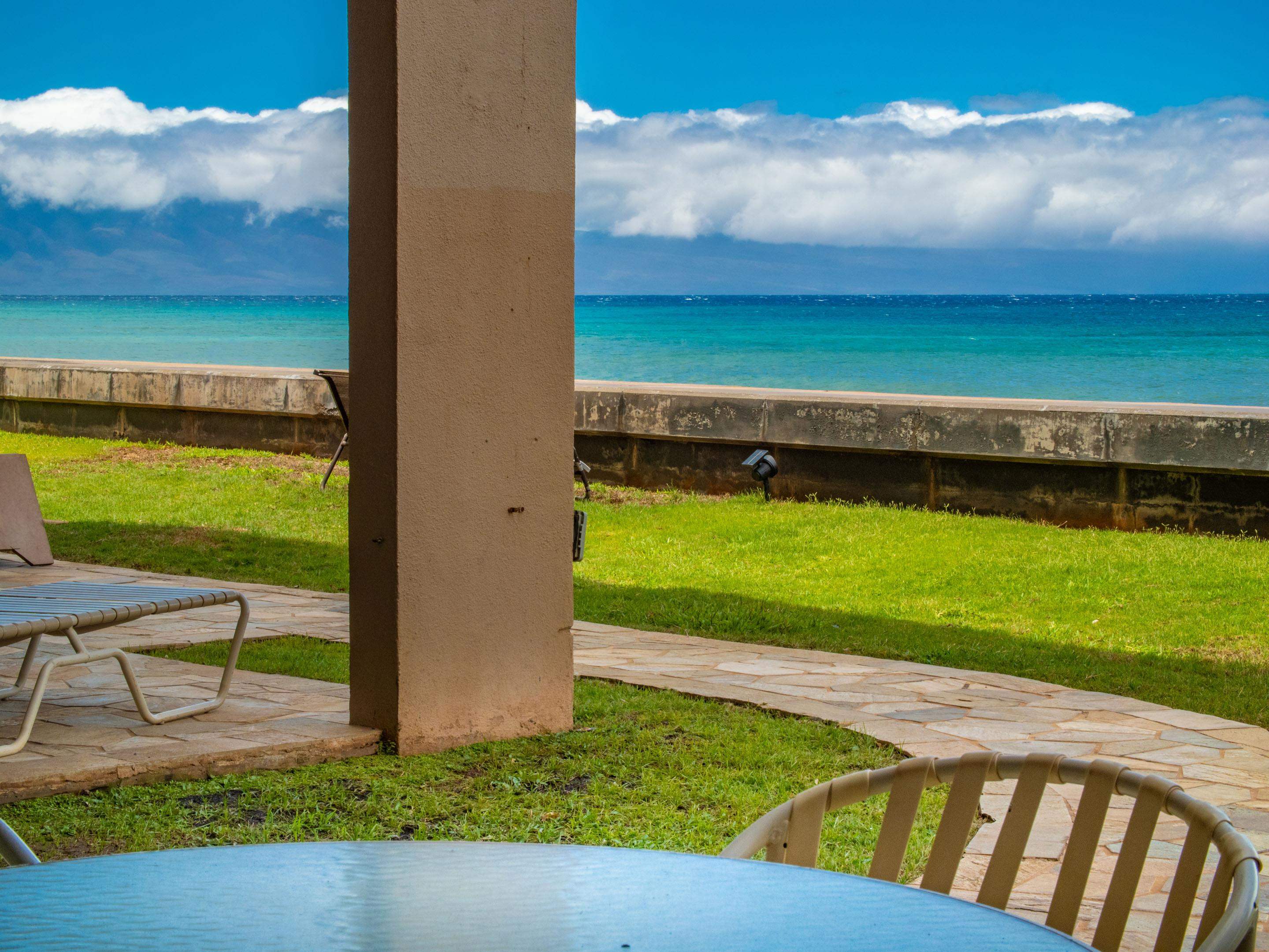 3723 Lower Honoapiilani Road, Unit 104 Lahaina, HI 96761 - Photo 16 of 45 a view of a backyard with plants and a lake view