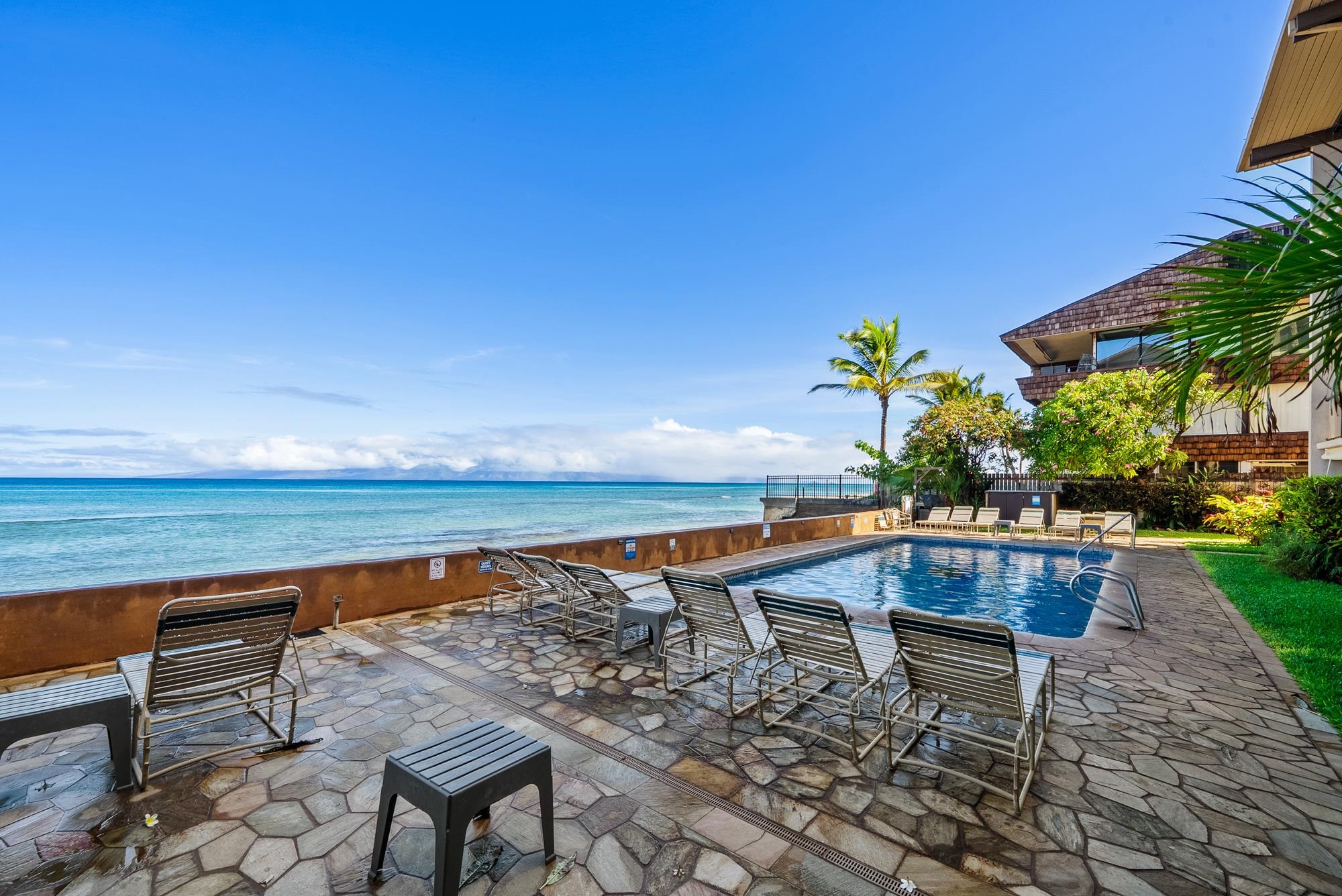 3723 Lower Honoapiilani Road, Unit 104 Lahaina, HI 96761 - Photo 38 of 45 a swimming pool with outdoor seating and yard