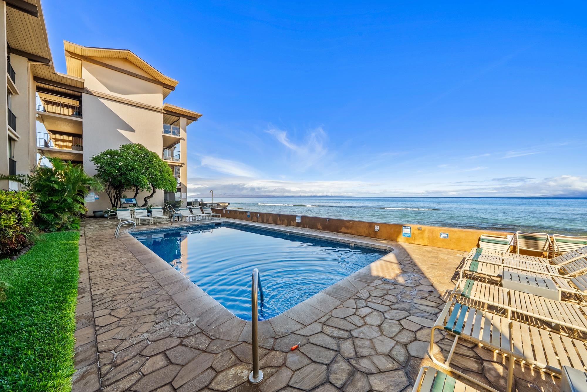 3723 Lower Honoapiilani Road, Unit 104 Lahaina, HI 96761 - Photo 40 of 45 a view of a swimming pool with a lounge chairs