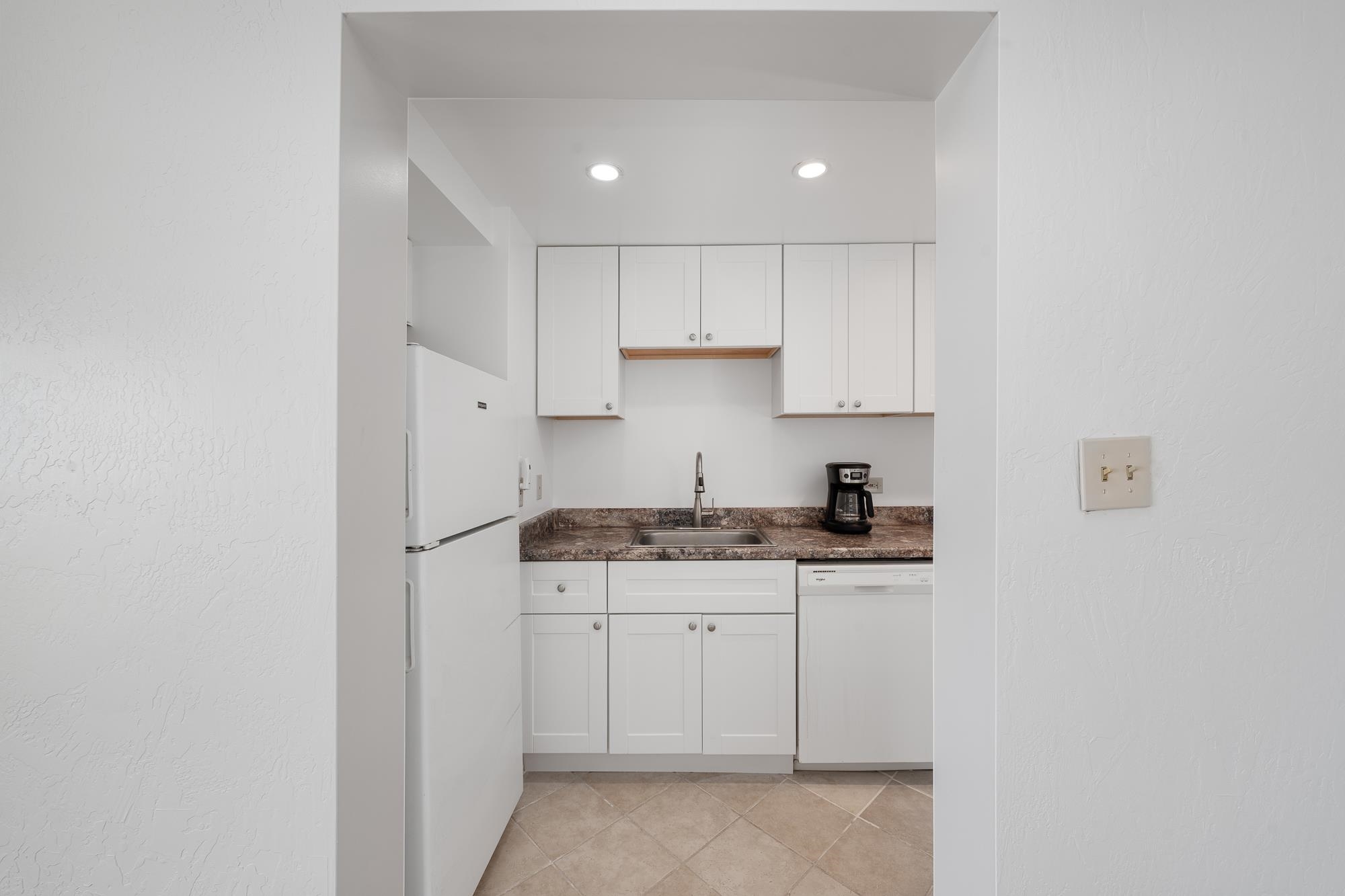 3723 Lower Honoapiilani Road, Unit 104 Lahaina, HI 96761 - Photo 4 of 45 a kitchen with granite countertop a sink and cabinets