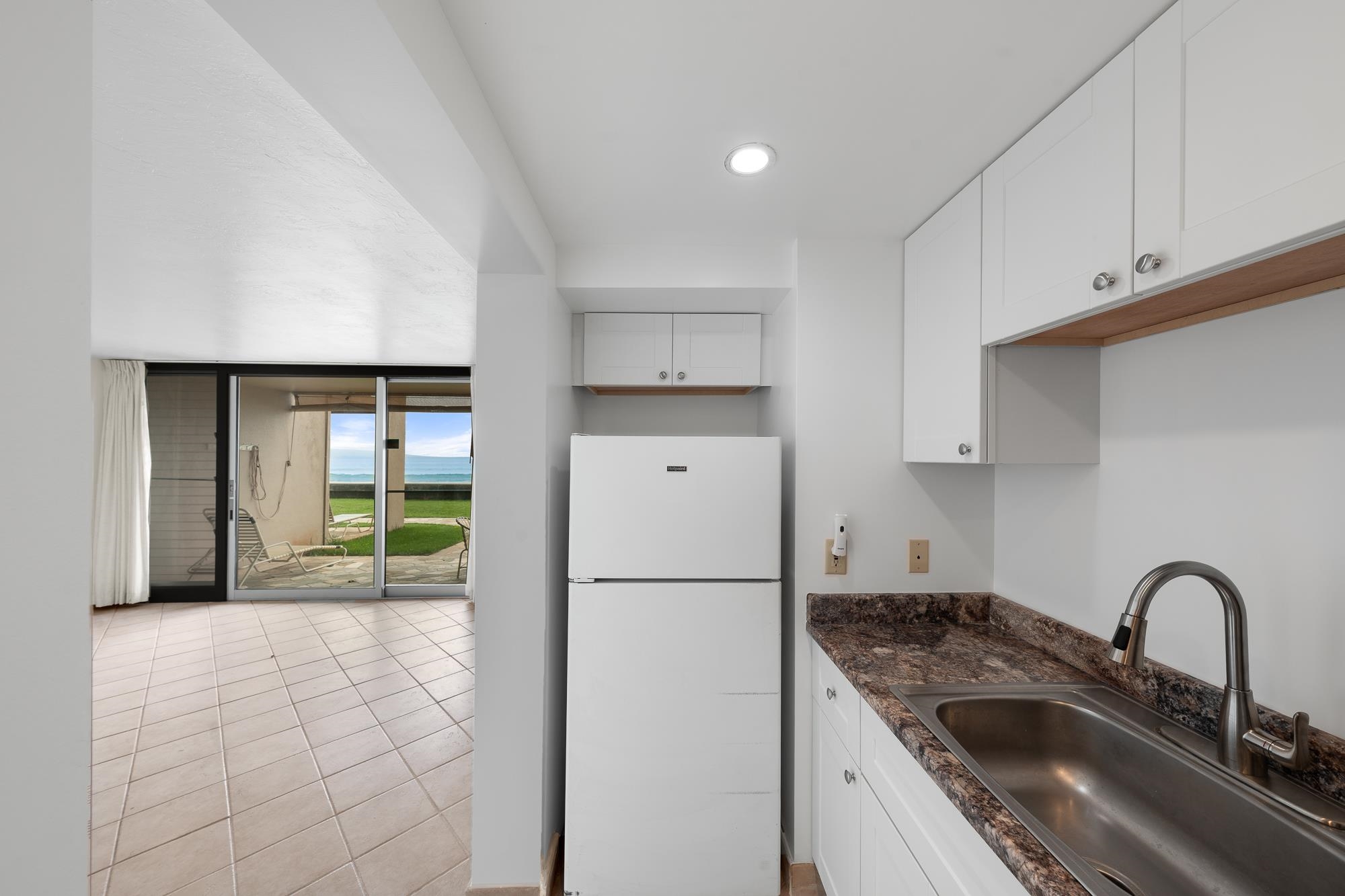 3723 Lower Honoapiilani Road, Unit 104 Lahaina, HI 96761 - Photo 5 of 45 a kitchen with a refrigerator and a sink