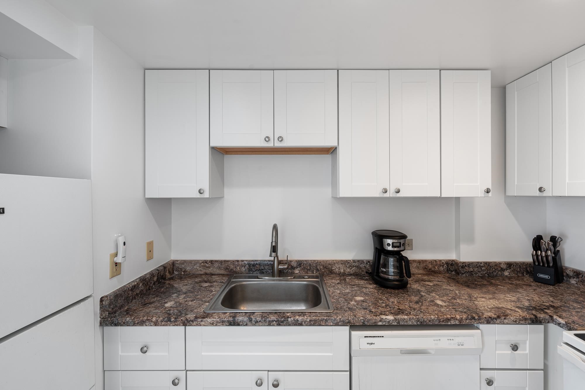 3723 Lower Honoapiilani Road, Unit 104 Lahaina, HI 96761 - Photo 6 of 45 a kitchen with granite countertop white cabinets and sink