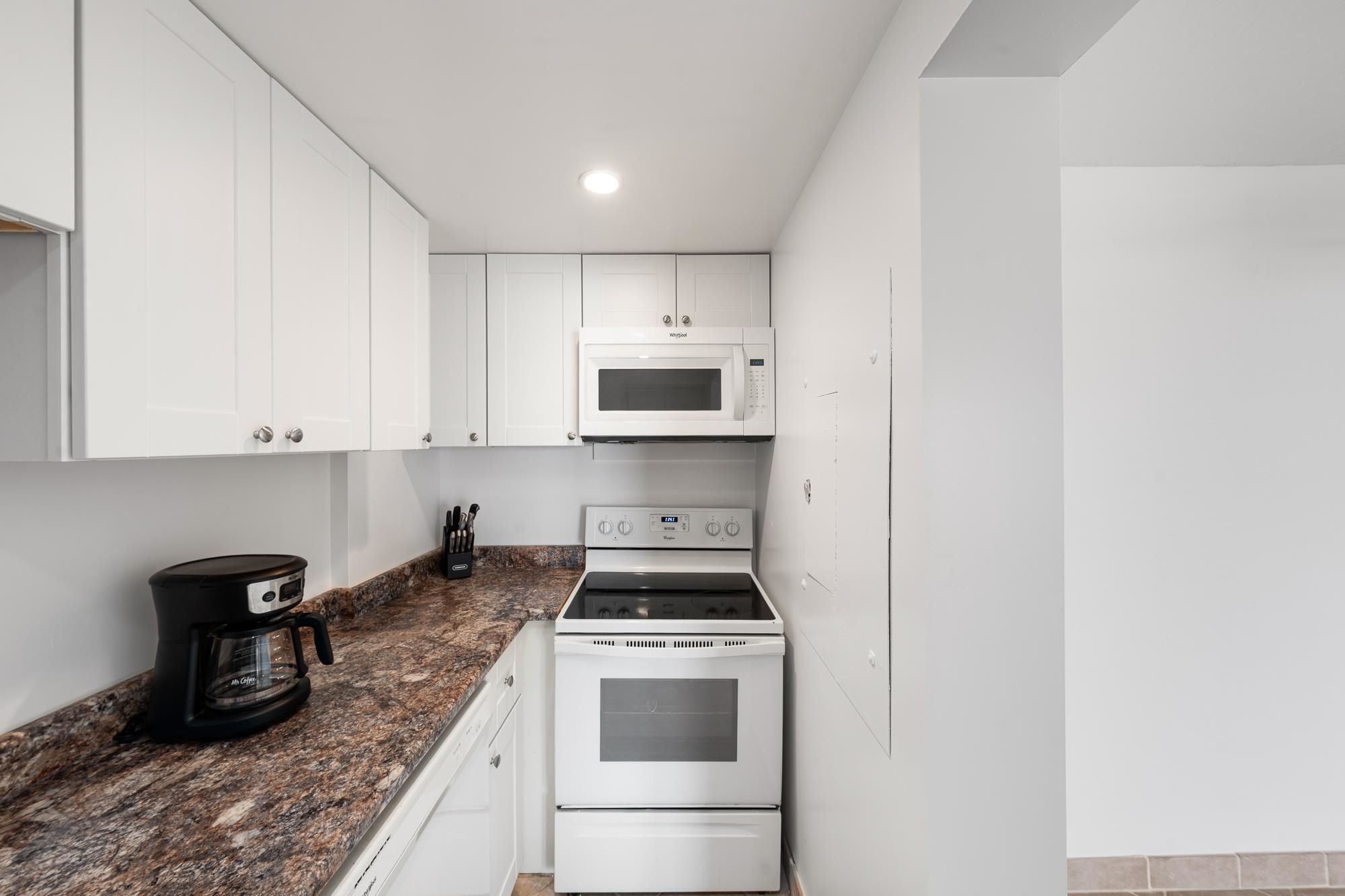 3723 Lower Honoapiilani Road, Unit 104 Lahaina, HI 96761 - Photo 7 of 45 a kitchen with granite countertop a stove and a sink