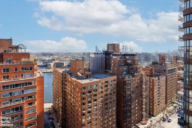 a bedroom with a bed couch and a large window