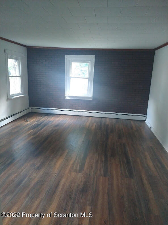 106 T Rte 718 Moscow, PA 18444 - Photo 3 of 15 an empty room with wooden floor and windows