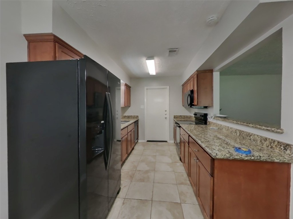 4227 Burkegate Drive Spring, TX 77373 - Photo 5 of 15 a kitchen with stainless steel appliances granite countertop a refrigerator and a sink