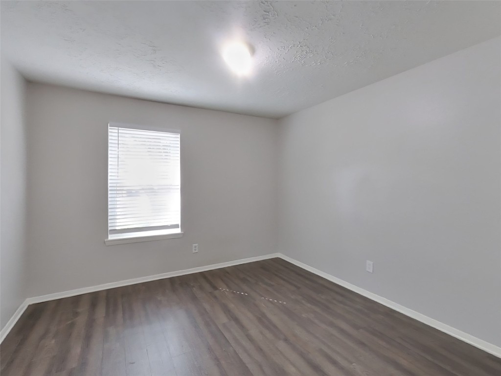 4227 Burkegate Drive Spring, TX 77373 - Photo 6 of 15 an empty room with wooden floor and windows