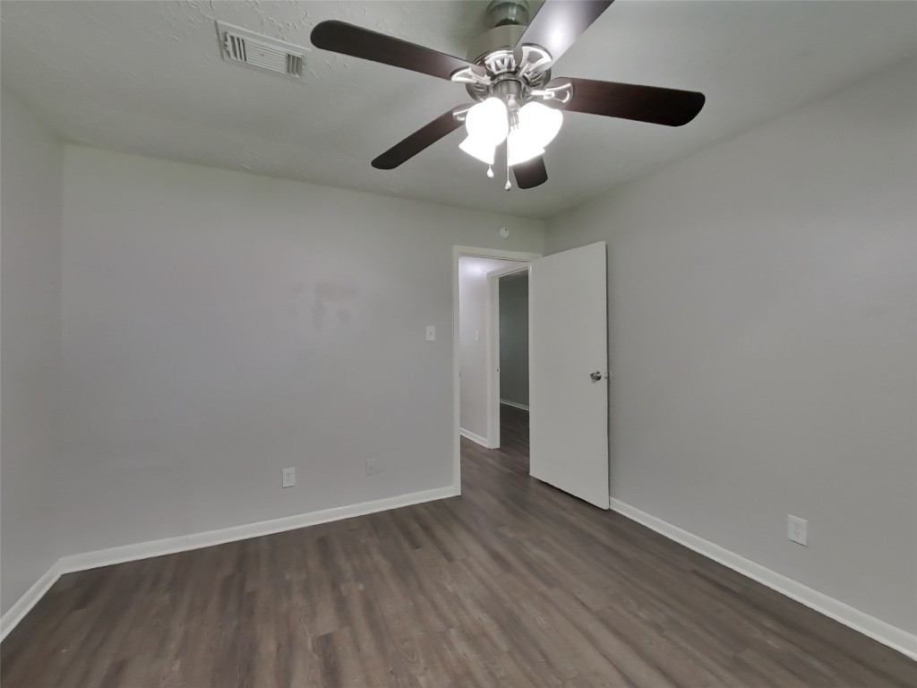 4227 Burkegate Drive Spring, TX 77373 - Photo 9 of 15 an empty room with wooden floor chandelier fan and closet area