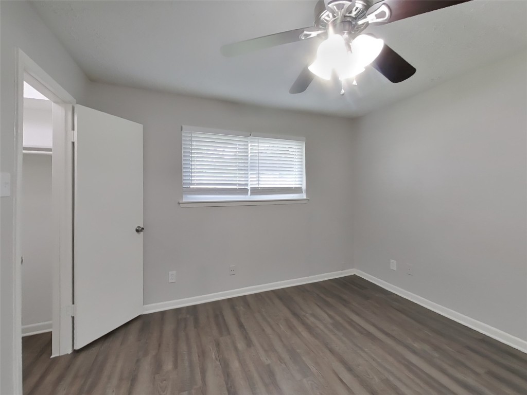 4227 Burkegate Drive Spring, TX 77373 - Photo 10 of 15 an empty room with wooden floor chandelier fan and windows