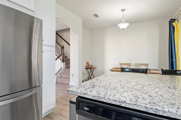 a view of a kitchen counter and a refrigerator