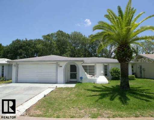 8930 Candlewick Lane Port Richey, FL 34668 - Photo 1 of 1 a front view of house with yard and green space