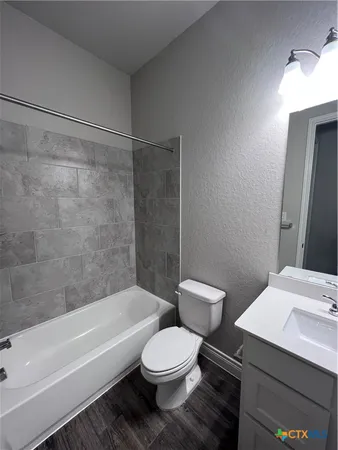 a bathroom with a toilet a sink and bathtub