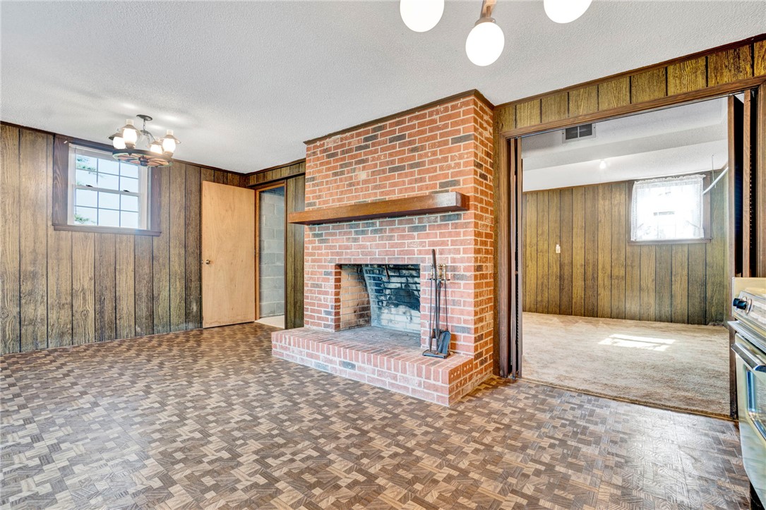 7876 Highway 11 Walhalla, SC 29691 - Photo 30 of 35 A classic brick fireplace with a wood mantle anchors this inviting living space.