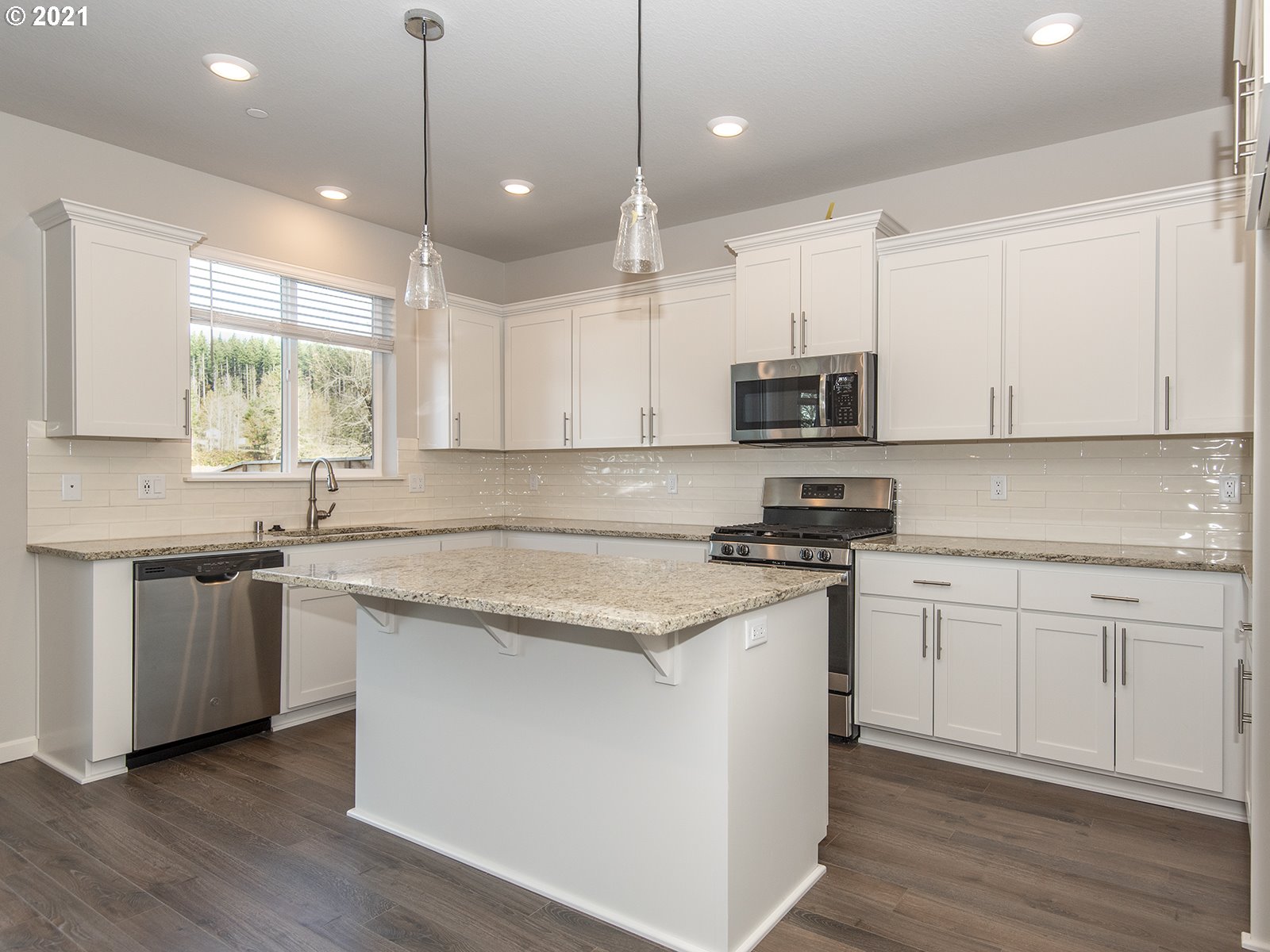 3742 South 42nd Place Ridgefield, WA 98642 - Photo 20 of 32 a kitchen with stainless steel appliances granite countertop a stove a sink and a microwave