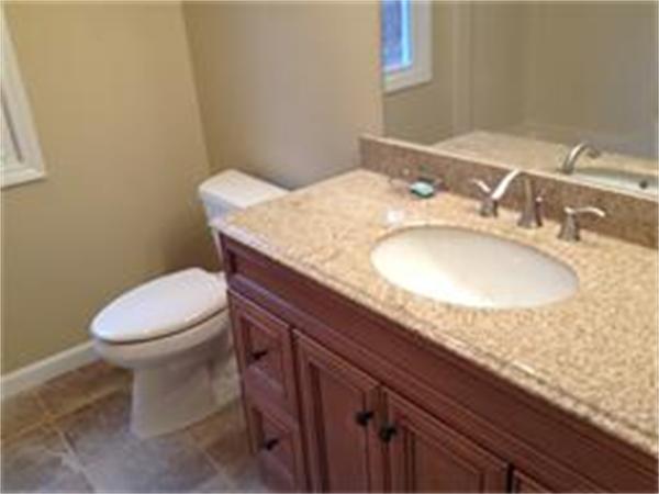 365 Pleasantdale Road Rutland, MA 01543 - Photo 10 of 11 a bathroom with a granite countertop toilet sink and mirror