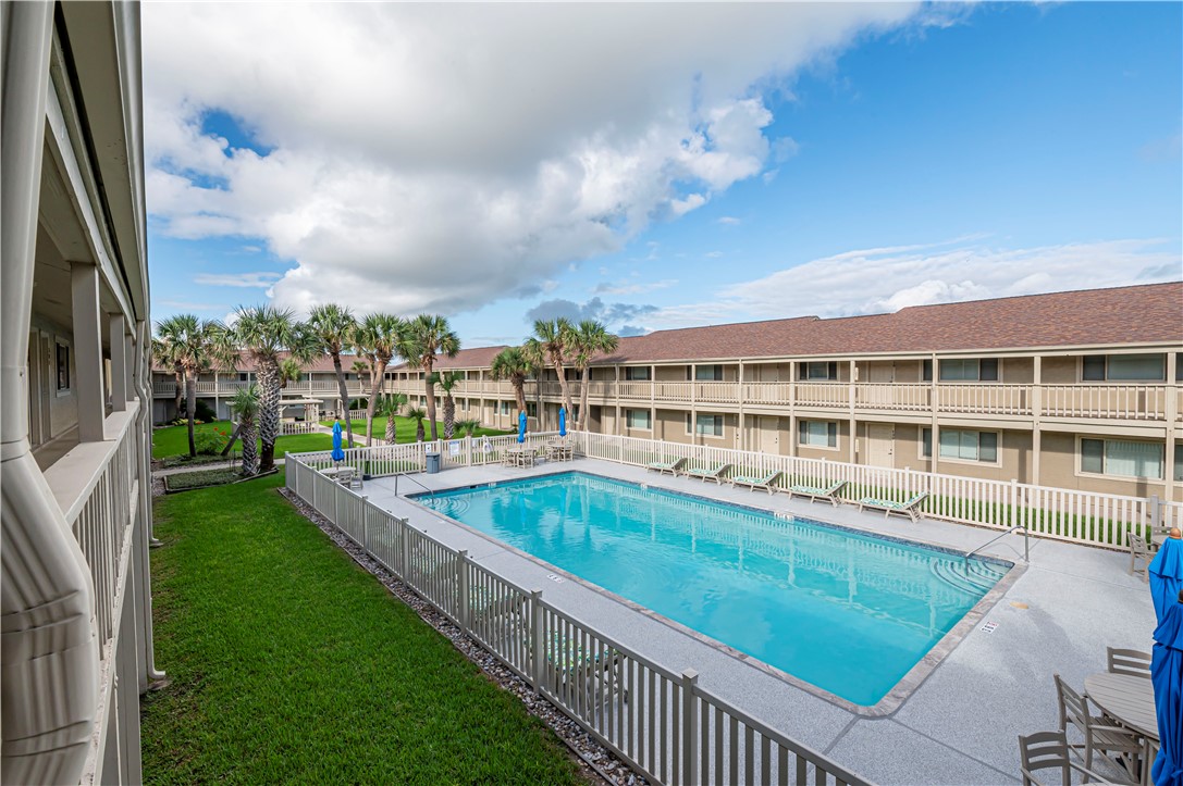 622 Beach Access Road Port Aransas, TX 78373 - Photo 12 of 19 a view of a swimming pool with a garden