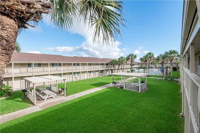 a view of a house with backyard porch and sitting area