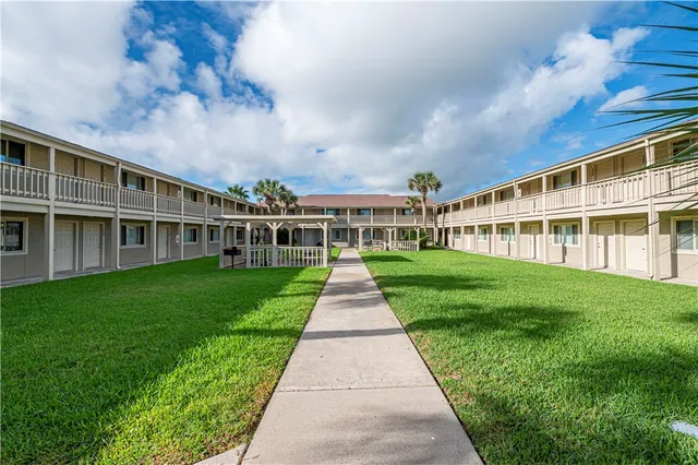 a view of house with a yard