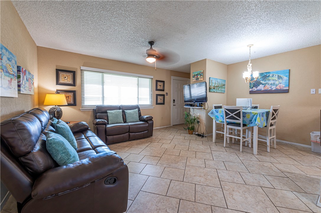 622 Beach Access Road Port Aransas, TX 78373 - Photo 4 of 19 a living room with furniture a dining table and a window