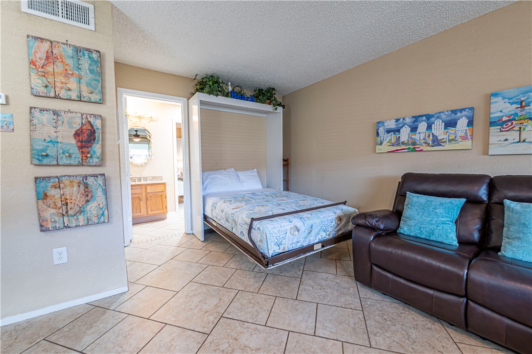 622 Beach Access Road Port Aransas, TX 78373 - Photo 5 of 19 a living room with furniture and a couch