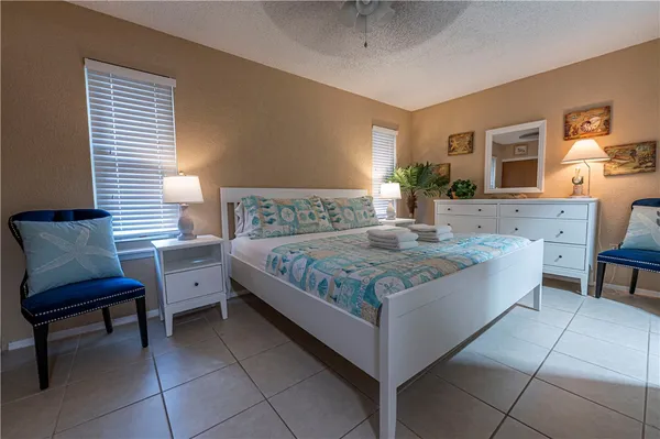 a bedroom with a bed and a chair