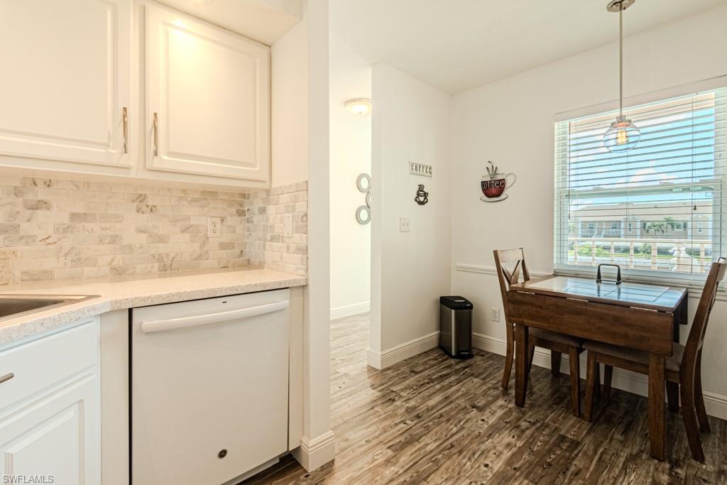 1850 West Crown Pointe Boulevard, Unit A202 Naples, FL 34112 - Photo 15 of 44 a view of a dining room with furniture and window