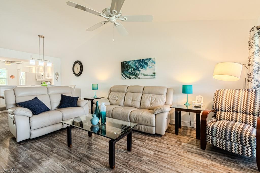 1850 West Crown Pointe Boulevard, Unit A202 Naples, FL 34112 - Photo 18 of 44 a living room with furniture and wooden floor