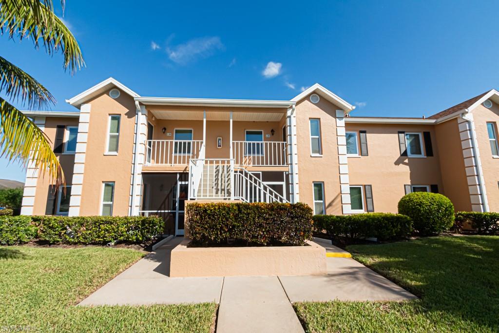 1850 West Crown Pointe Boulevard, Unit A202 Naples, FL 34112 - Photo 21 of 44 a front view of a house with a yard