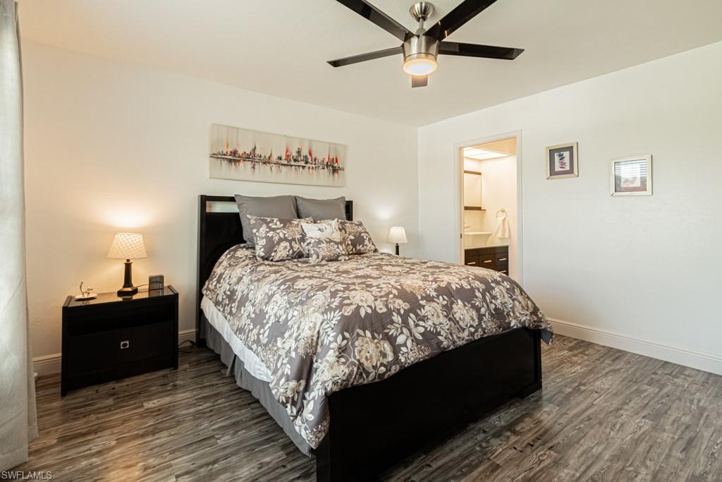 1850 West Crown Pointe Boulevard, Unit A202 Naples, FL 34112 - Photo 22 of 44 a bed sitting in a bedroom next to a window