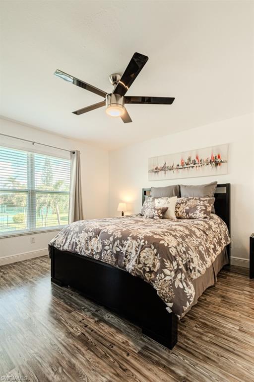 1850 West Crown Pointe Boulevard, Unit A202 Naples, FL 34112 - Photo 24 of 44 a bed sitting in a bedroom next to a window