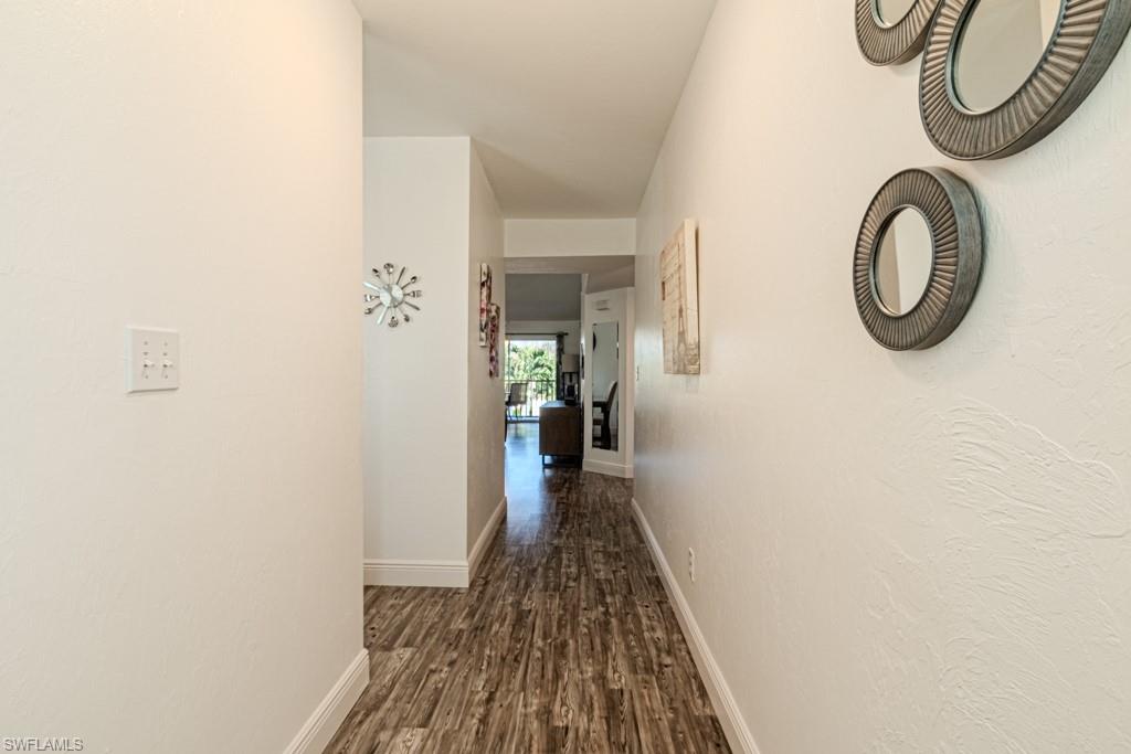 1850 West Crown Pointe Boulevard, Unit A202 Naples, FL 34112 - Photo 29 of 44 a view of a hallway with wooden floor