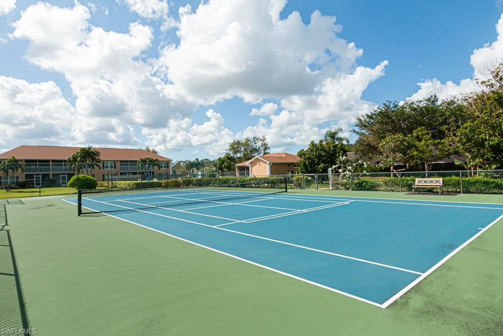 1850 West Crown Pointe Boulevard, Unit A202 Naples, FL 34112 - Photo 38 of 44 a view of an outdoor space and tennis court