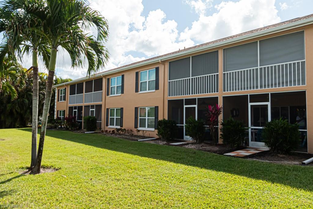 1850 West Crown Pointe Boulevard, Unit A202 Naples, FL 34112 - Photo 40 of 44 a front view of a house with a yard