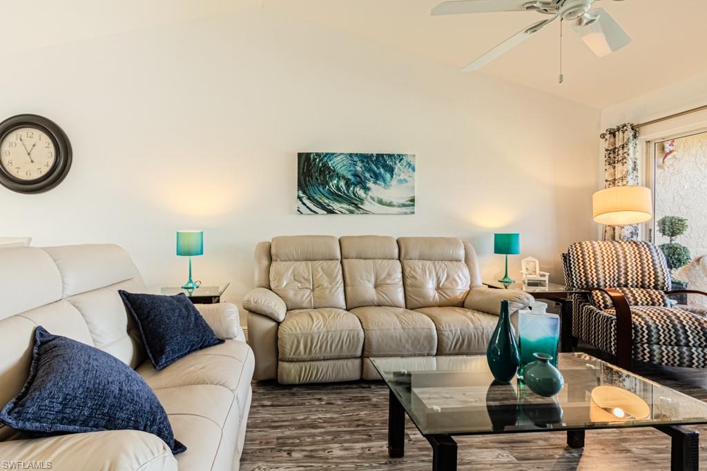 1850 West Crown Pointe Boulevard, Unit A202 Naples, FL 34112 - Photo 5 of 44 a living room with furniture and a mirror