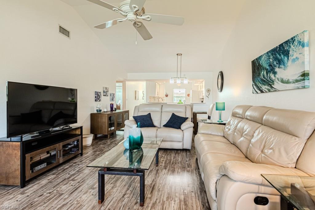 1850 West Crown Pointe Boulevard, Unit A202 Naples, FL 34112 - Photo 9 of 44 a living room with furniture and a flat screen tv