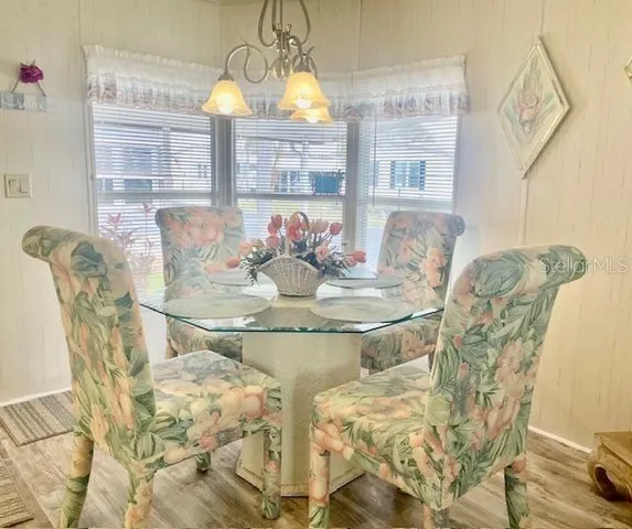 a view of a dining room with furniture and chandelier