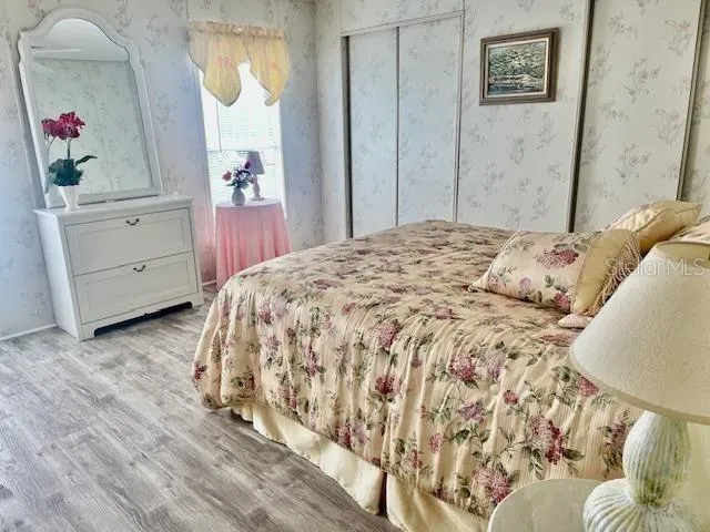 a bedroom with a bed and cabinets