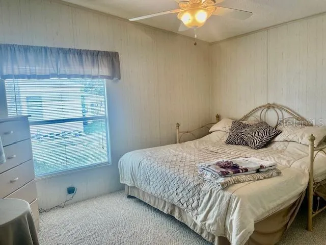 a living room with furniture and a painting on the wall