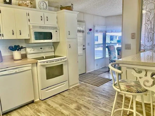 a kitchen with stainless steel appliances granite countertop a stove and a refrigerator