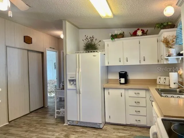 a kitchen with stainless steel appliances a refrigerator and cabinets