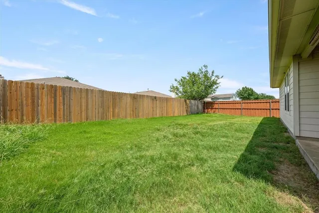 an aerial view of a house with garden space and street view