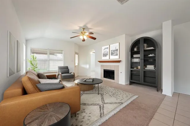 a living room with furniture a fireplace and a flat screen tv