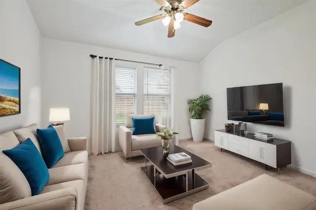 a living room with furniture and a flat screen tv