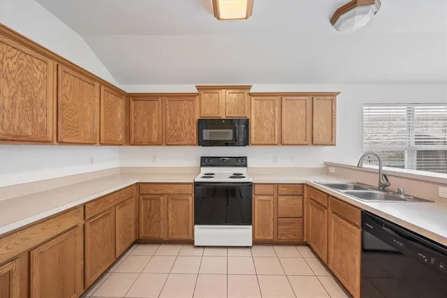 a kitchen with a sink cabinets and stainless steel appliances