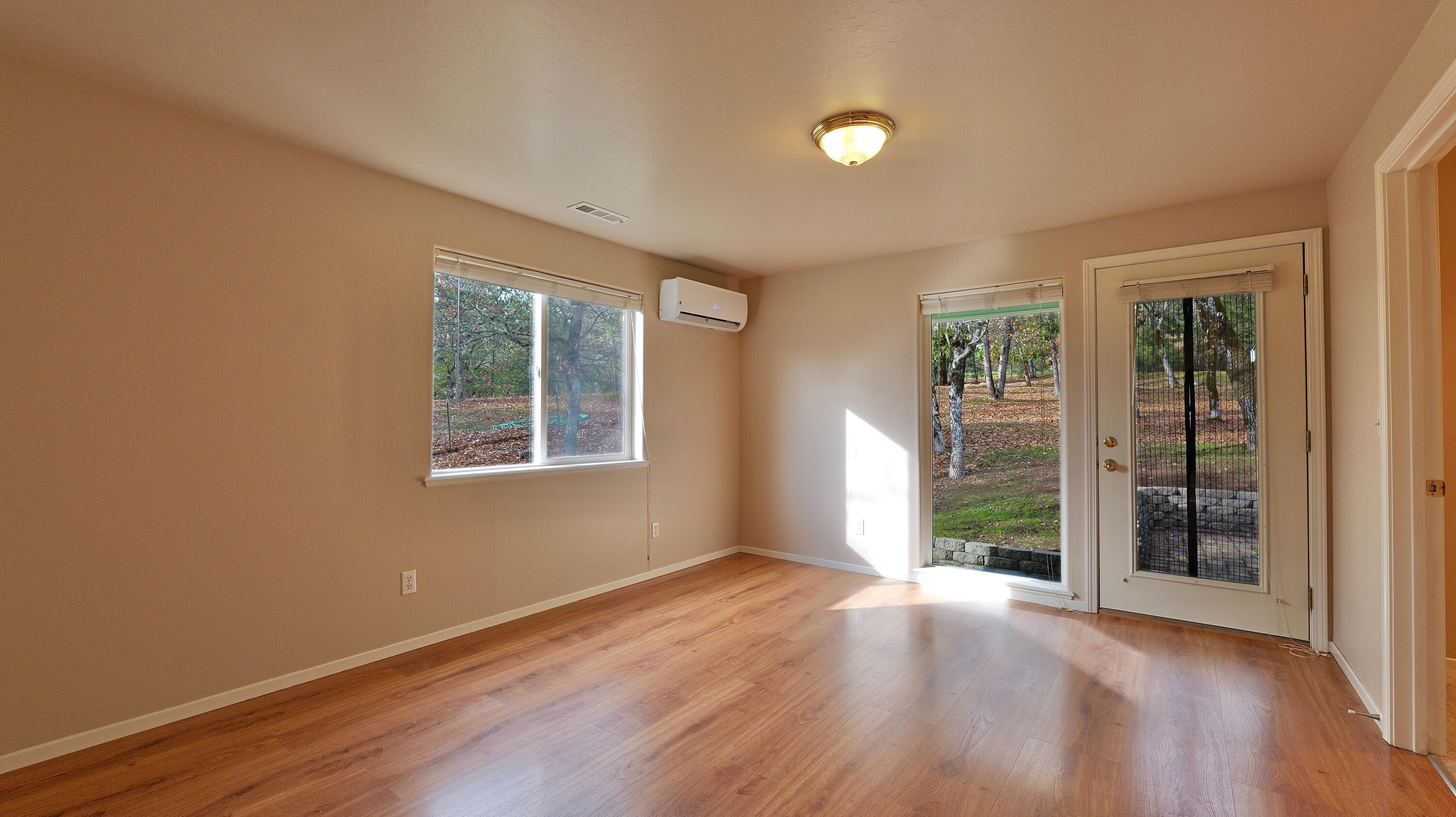 204 Shipley Terrace Prospect, OR 97536 - Photo 20 of 61 an empty room with wooden floor and windows