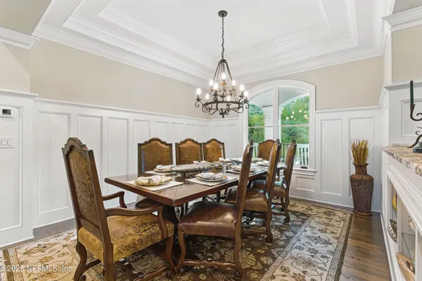 a living room with furniture fireplace and a large window