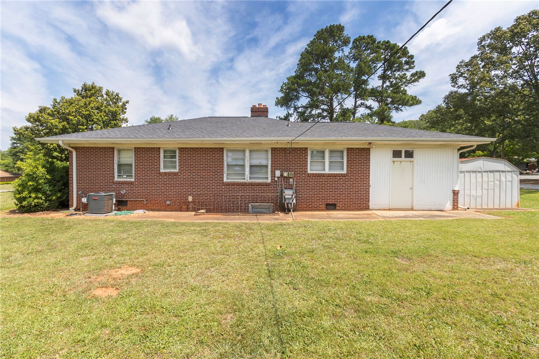 1218 Bolt Drive Anderson, SC 29621 - Photo 39 of 46 A well-kept brick exterior home with a green lawn and a convenient storage shed.