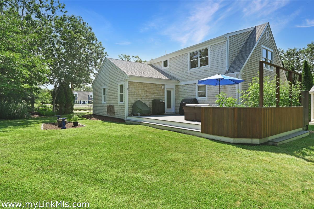 63 Saddle Club Road Edgartown, MA 02539 - Photo 2 of 2 a view of a house with a backyard and a tree